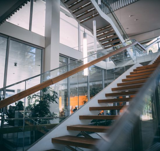 A modern room with a wooden staircase during daytime