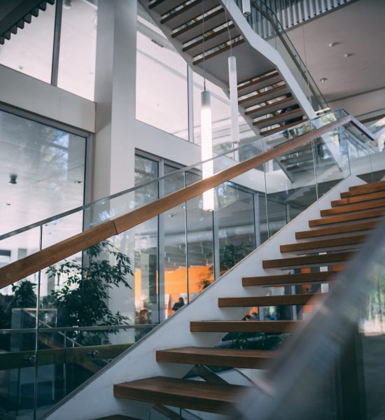 A modern room with a wooden staircase during daytime