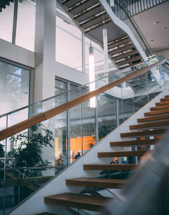 A modern room with a wooden staircase during daytime